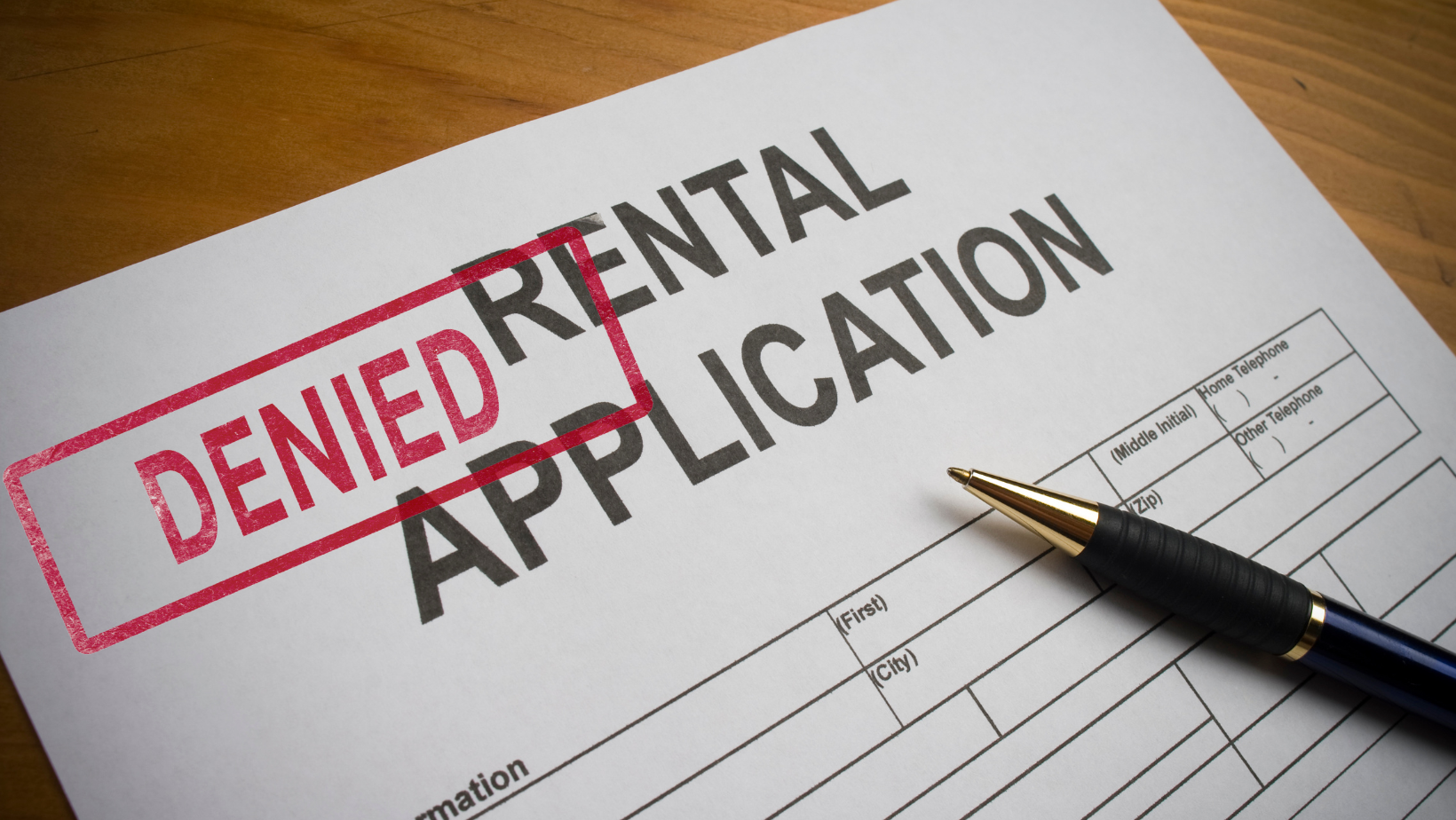 A rental application with a red denied stamp.